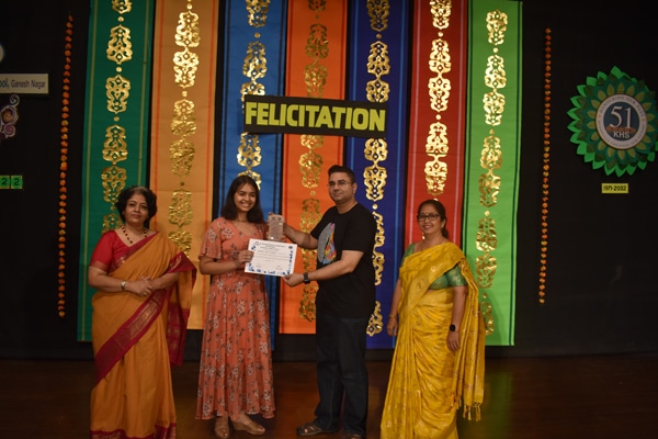 A bright student at the felicitation ceremony by the hands of the chief guest.