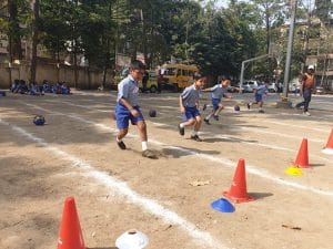 Kalmadi Shamarao Pre-Primary school students enjoying playing on the ground.