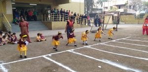 Kindergarten class students performing sports
