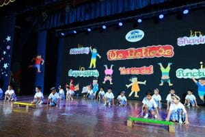 Students confidently performing on the stage with utmost coordination and perfect discipline.